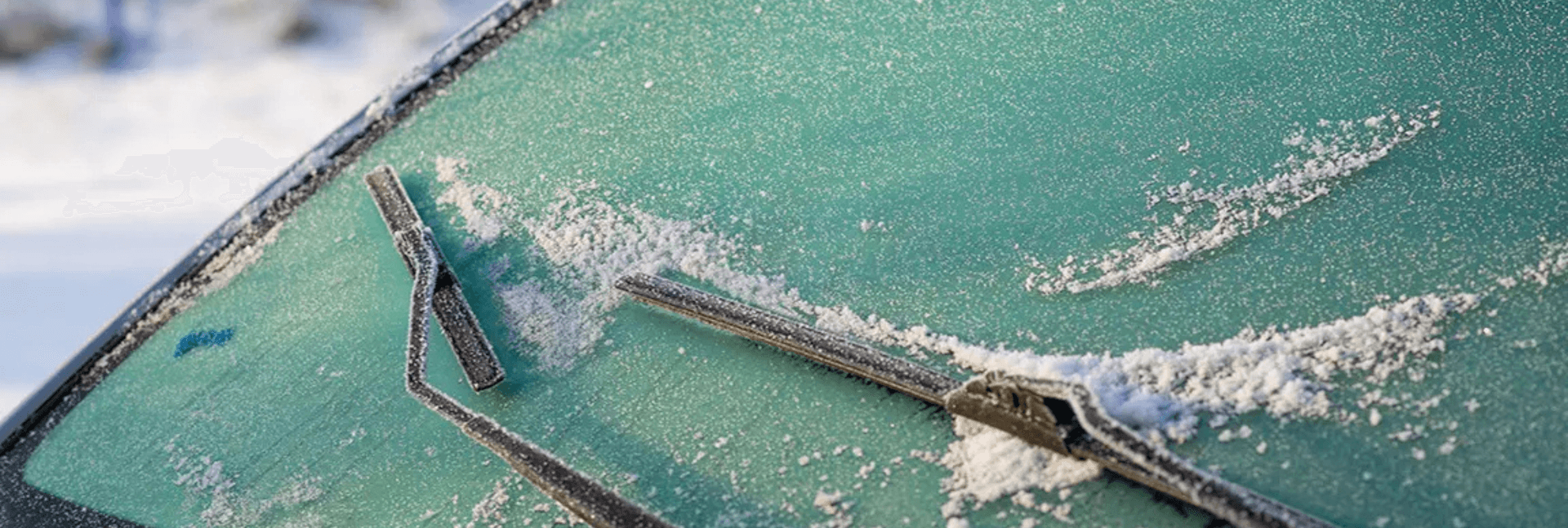 Windshield covered in ice.