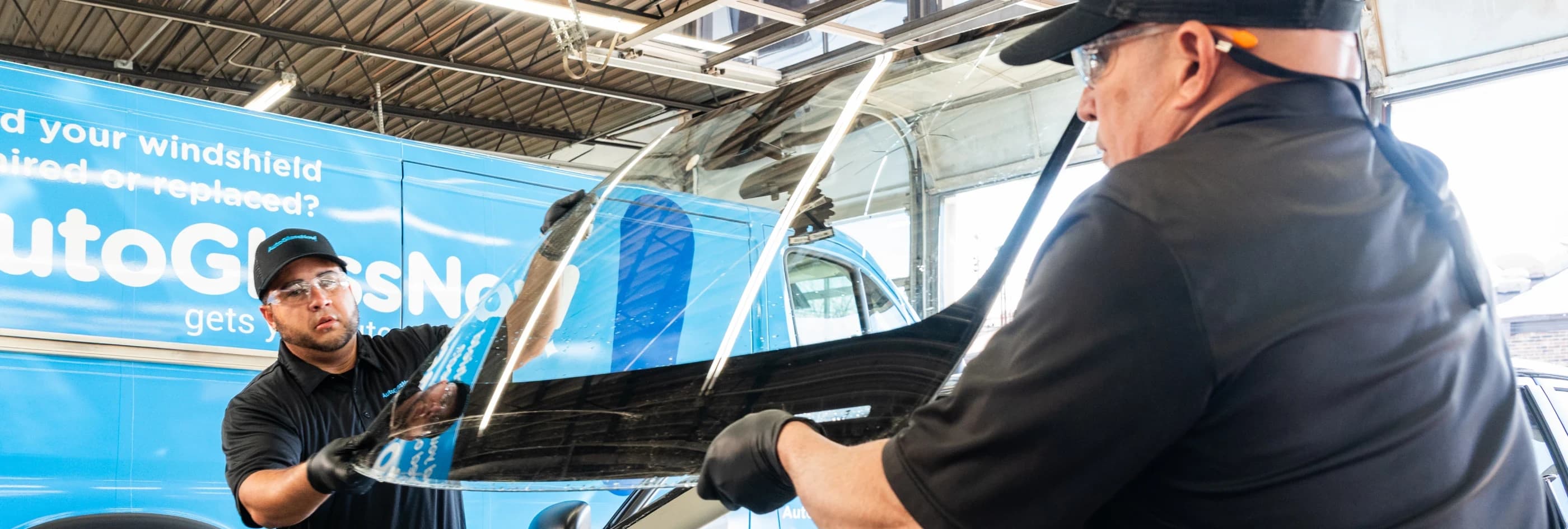 Auto Glass Now technicians replacing a windshield.