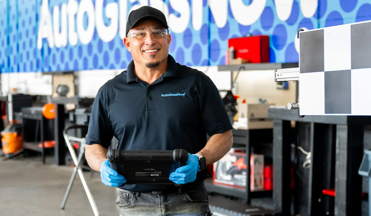 Smiling technician holding ipad static calibration