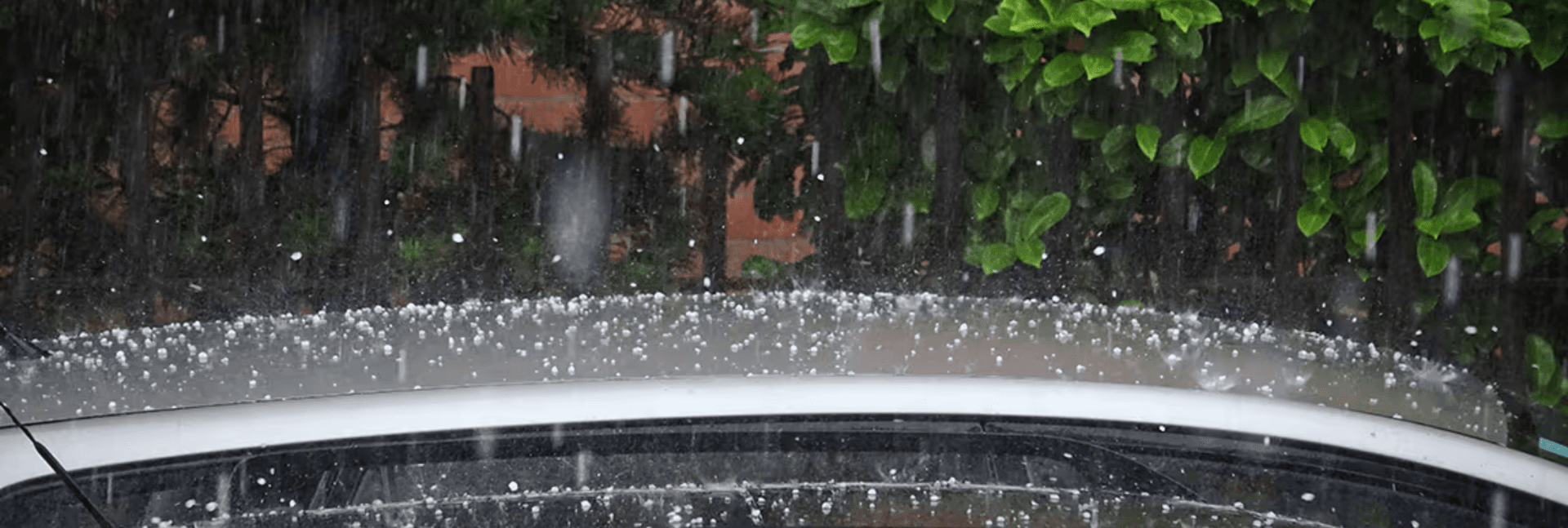 Hail falling on the roof of a car.