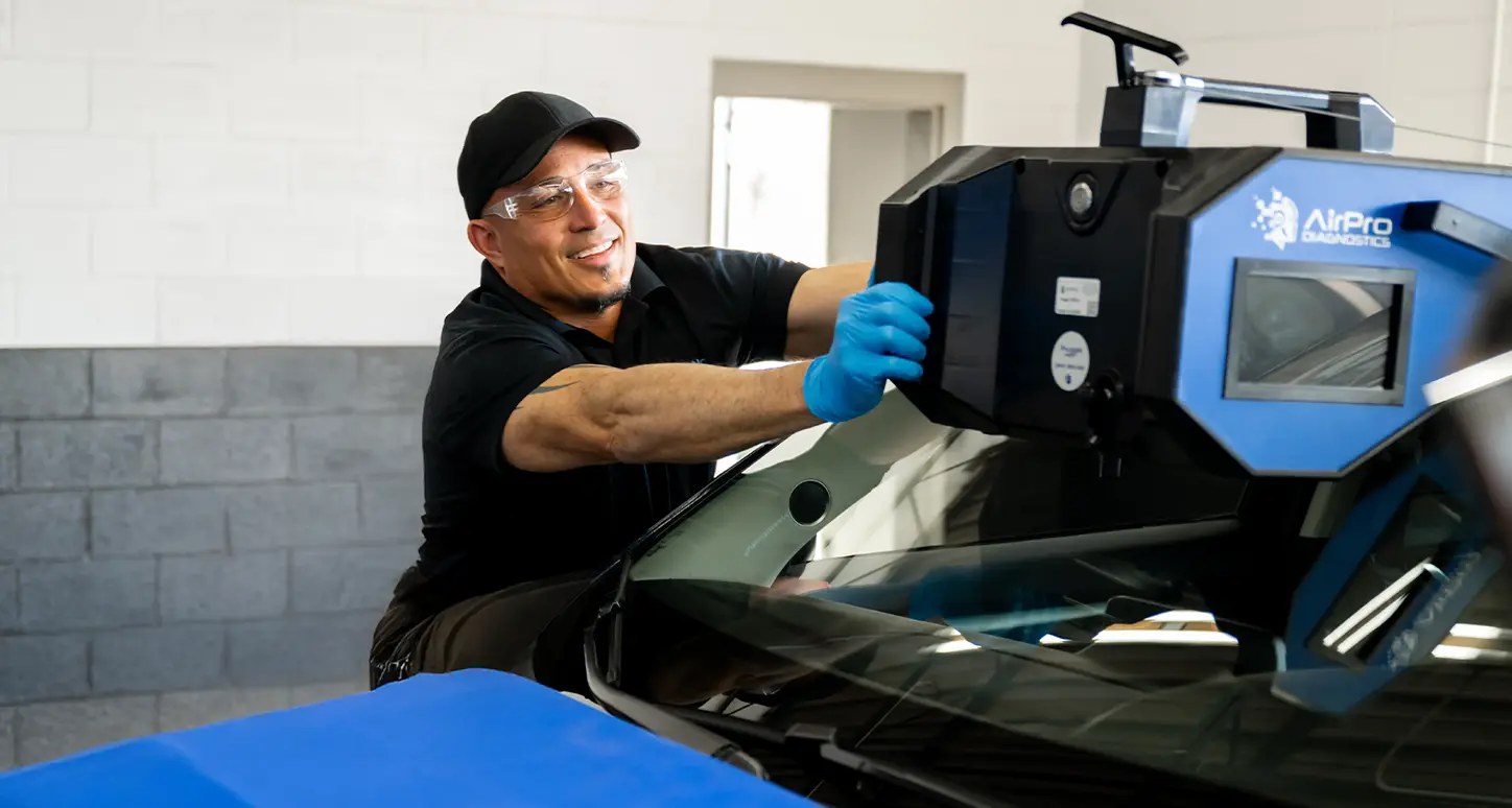 Technician performing windshield calibration