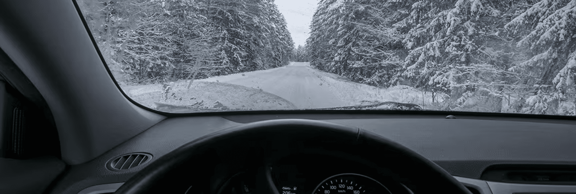 Winter weather viewed through a windshield.