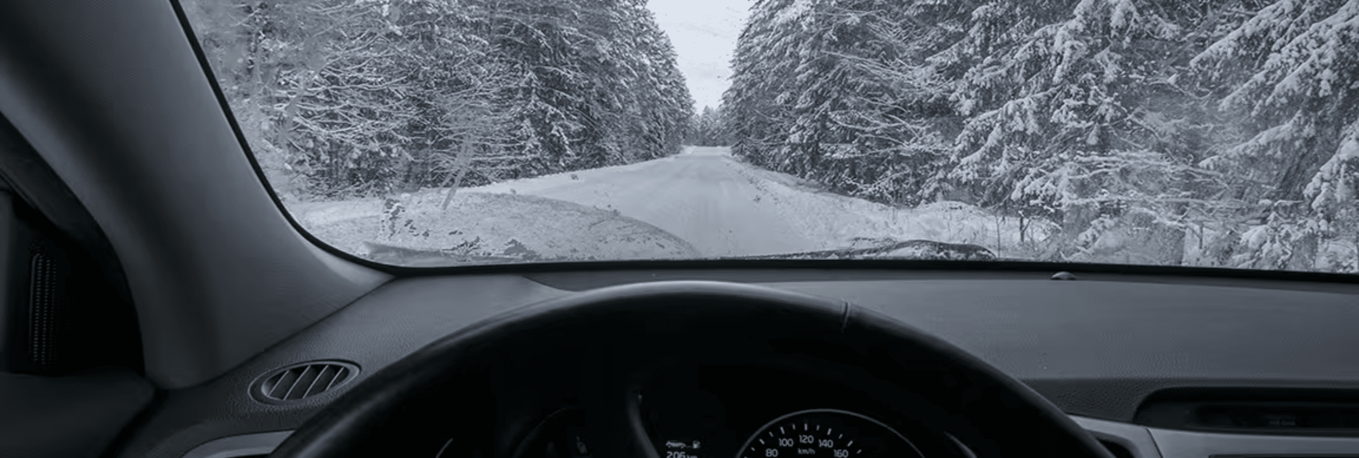 Winter weather viewed through a windshield.
