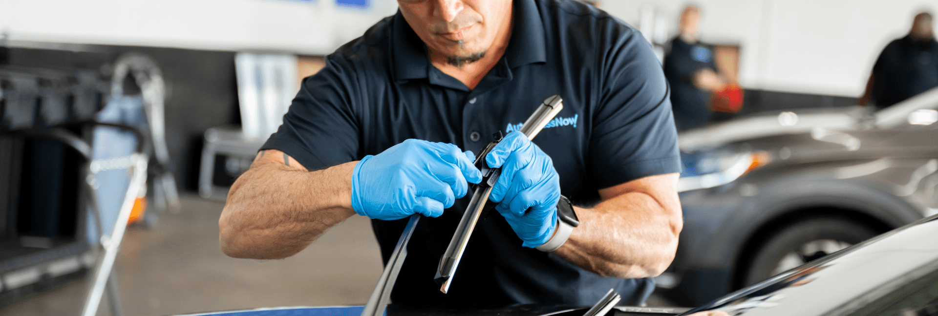 Windshield wiper being replaced by Auto Glass Now technician.