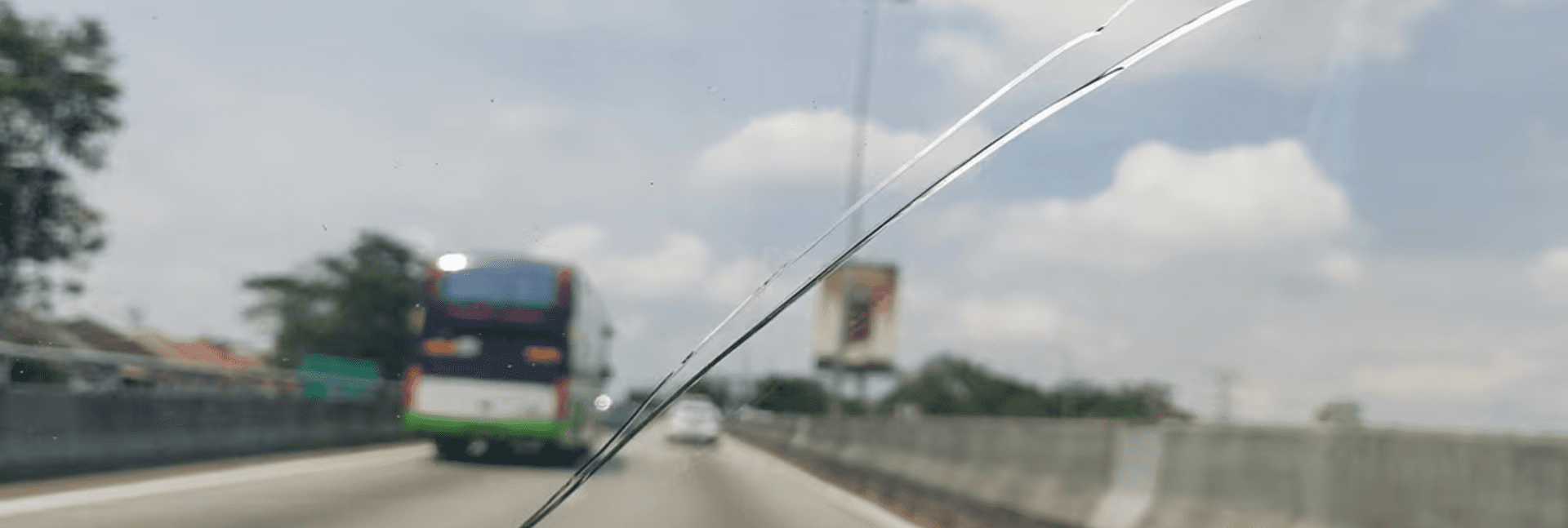 The view through a cracked windshield from inside the car.