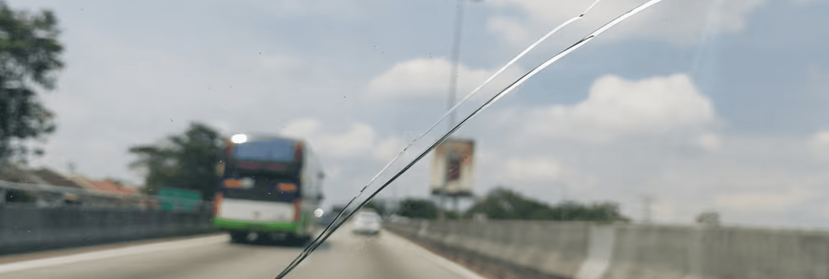 The view through a cracked windshield from inside the car.