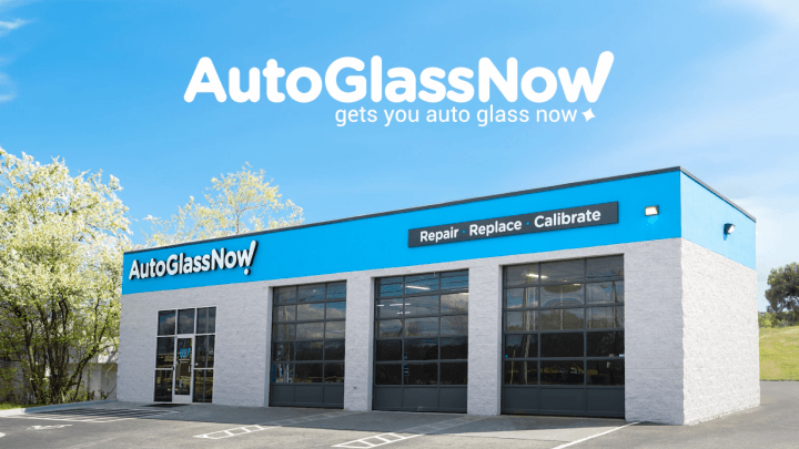 AutoGlassNow store with a blue and white facade, offering repair, replace, and calibrate services.