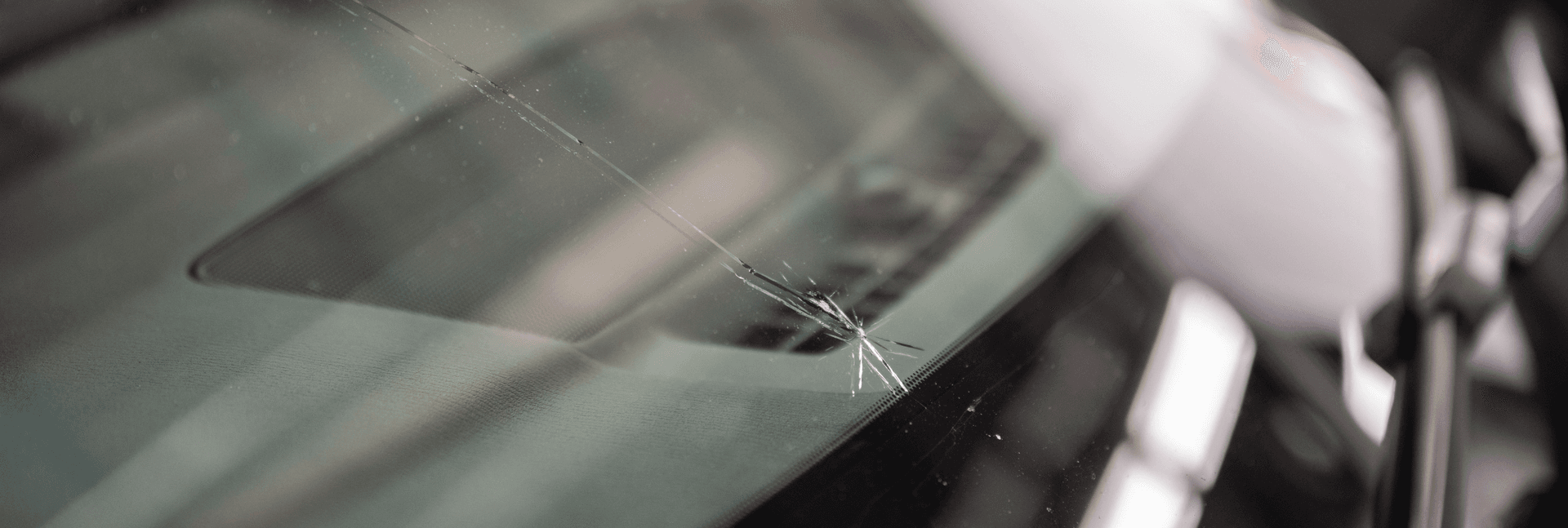 Cracked windshield in need of repair.