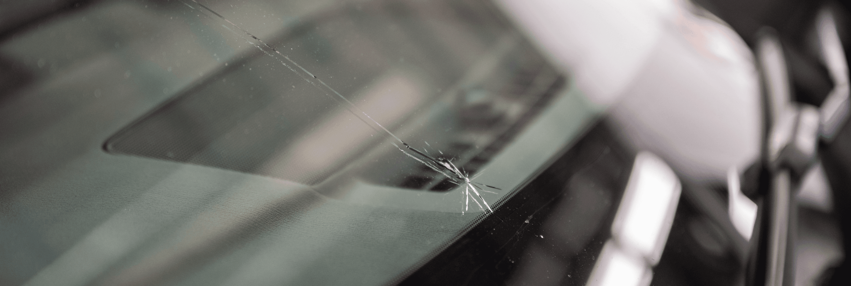 Cracked windshield in need of repair.