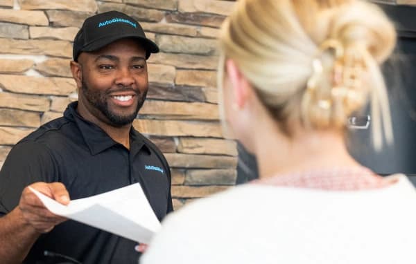 AGN employee holding insurance paper