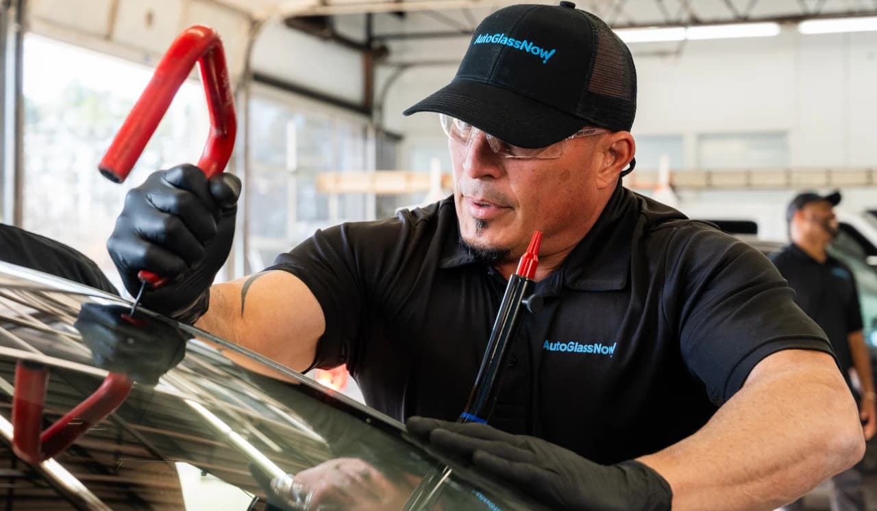 Mechanics repairing a windshield