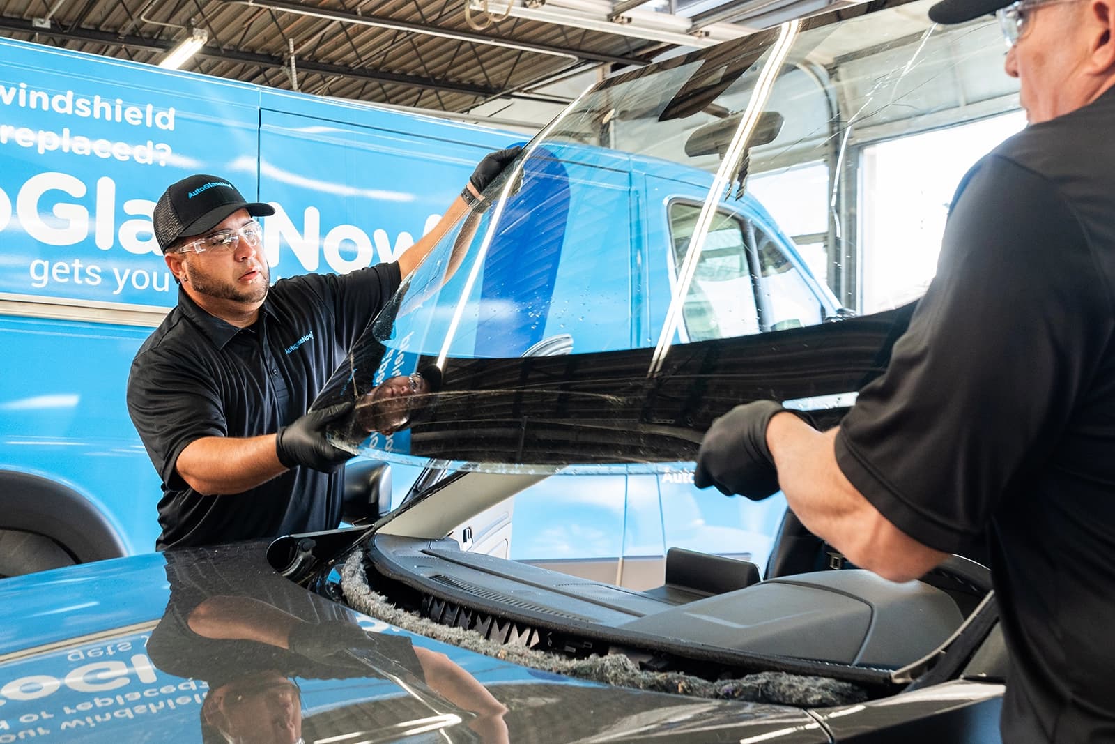 Technicians are replacing the windshield.