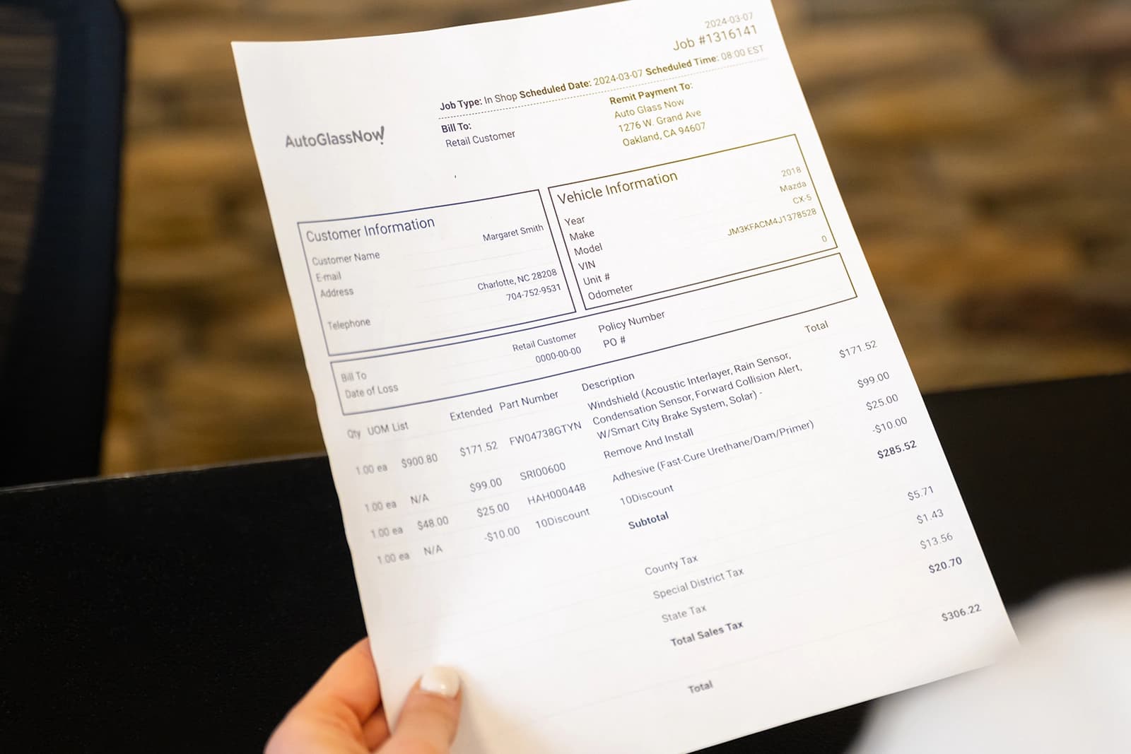 Customer holding invoice.